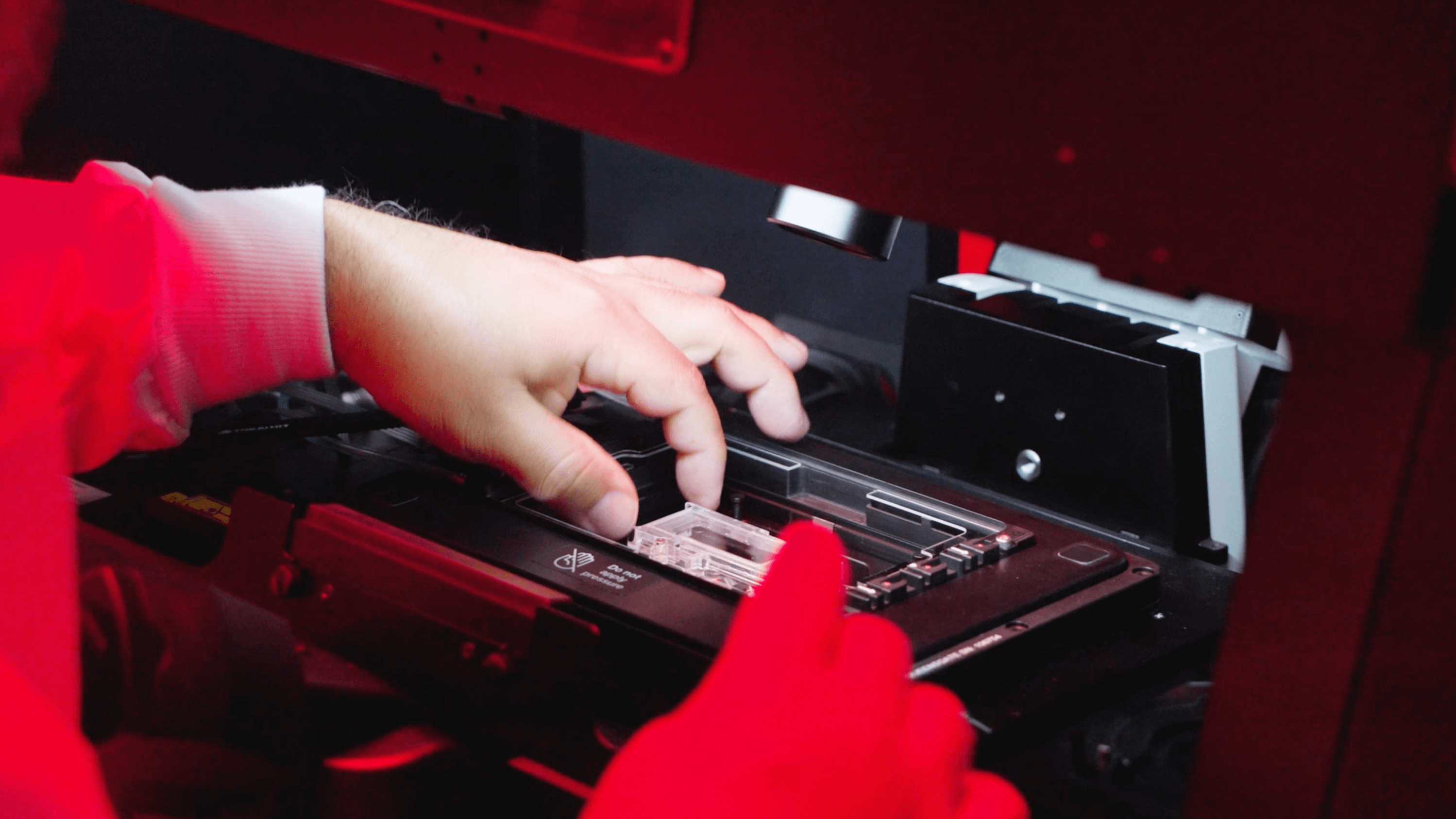 Hands putting cells on a screen